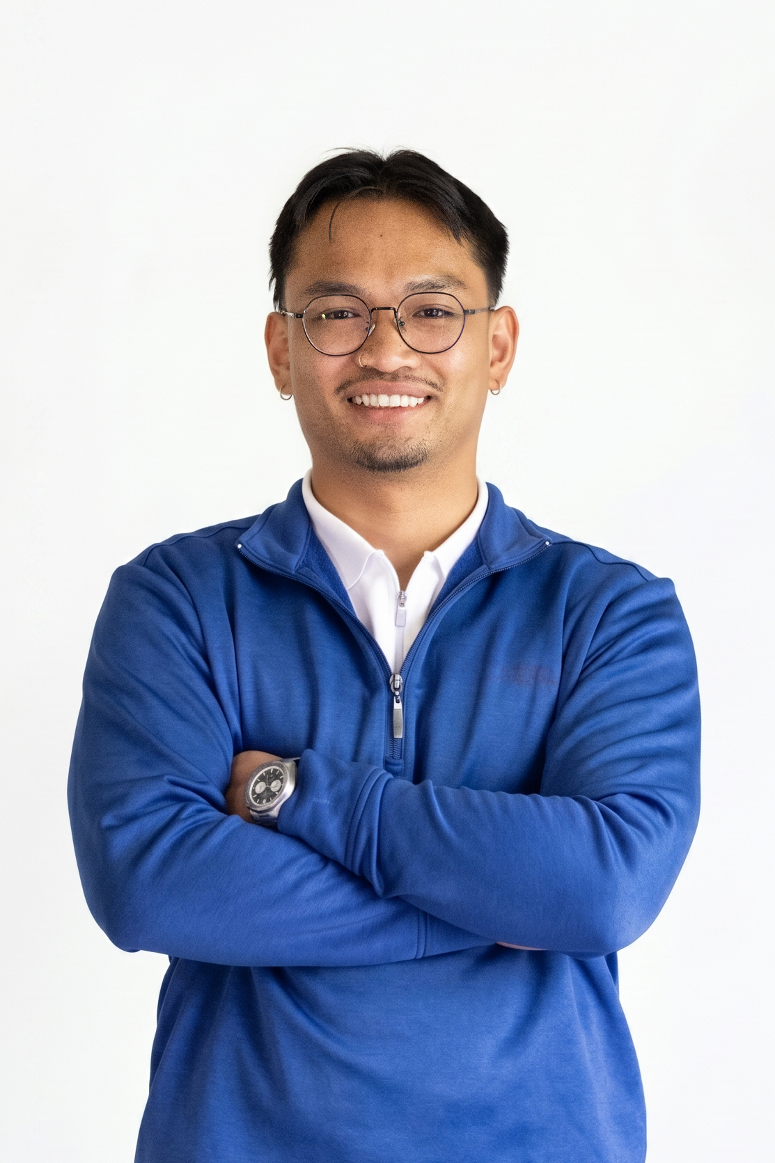 Tony Souknalong smiling with his arms crossed